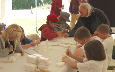Ingrid teaches soap carving to children at Dead Creek Wildlife Day