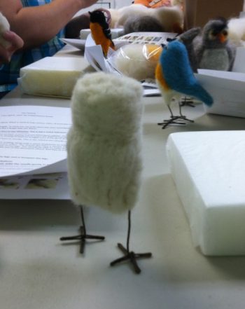 making a felted owl: Work In Process 1 (white wool loosely felted around wire legs in a rough bird body and head shape,, standing)