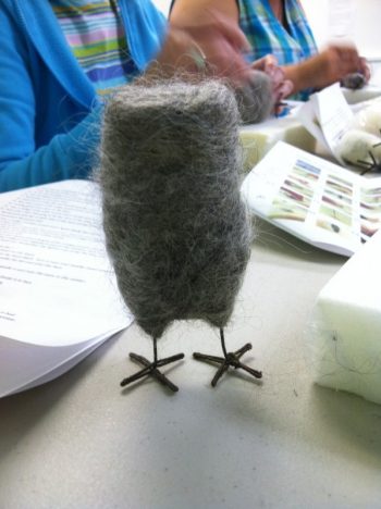 making a felted owl: Work In Process 3 (gray wool has been needled to the white wool inner body. Owl is standing on its wire legs for photo)