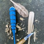 Three wooden feathers (painted, carved, and burned) and one knife. WIP by Bob Lindemann.