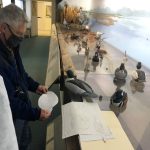 Bob Lindemann compares Dick Allen's Common Merganser carving to some planning drawings.