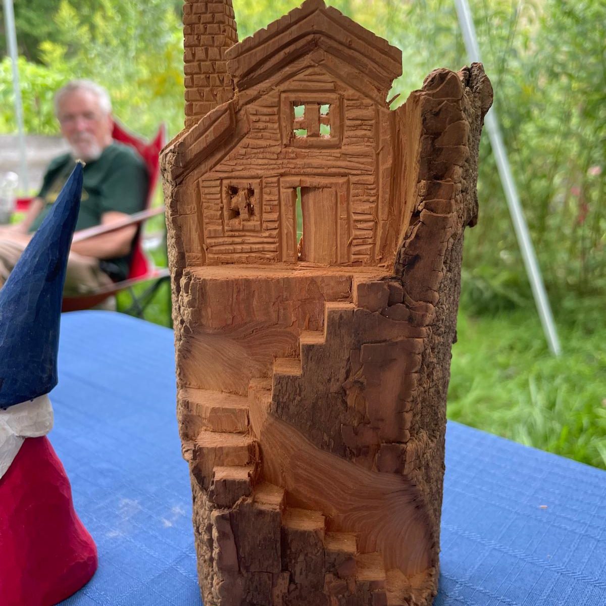A carving of a house atop a curving stair.